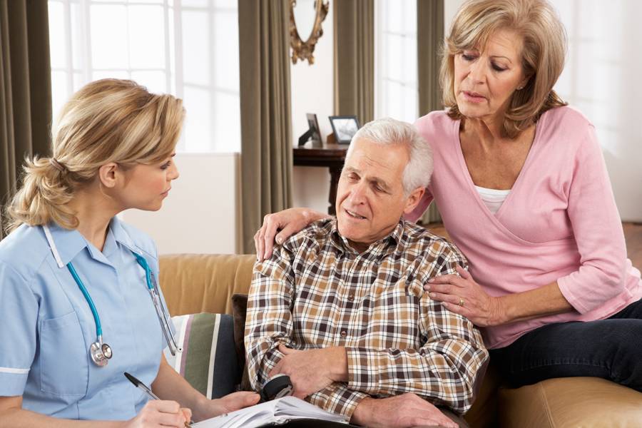 Senior couple talking to a nurse