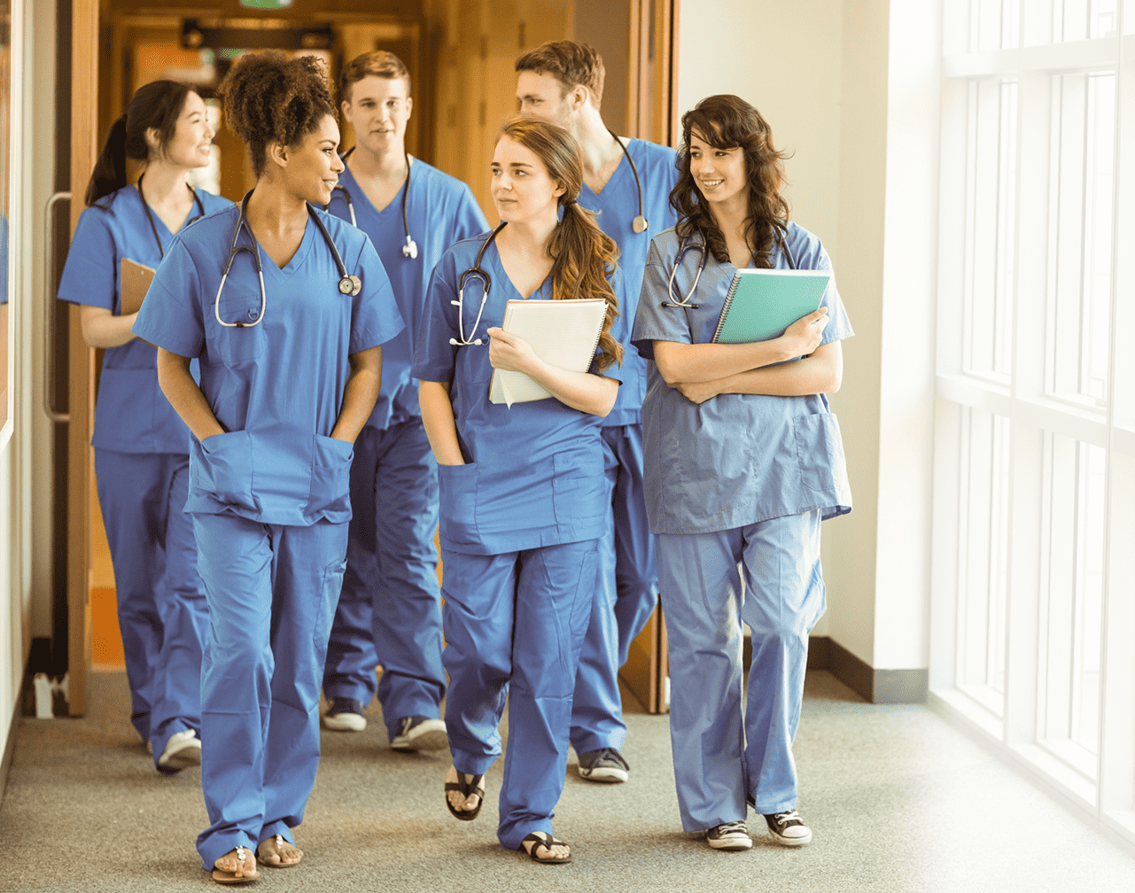 group of nurses walking in a hospital